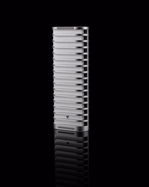 Stacked metal heatsink or thermal dissipation component photographed against black background